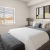 a bedroom with a bed and a lamp