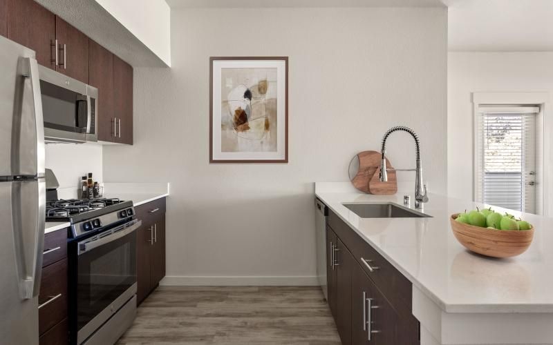 a kitchen with a sink and a stove