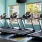 a room with a row of treadmills
